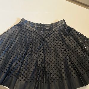 Club Monaco navy blue laser cut leather skirt.